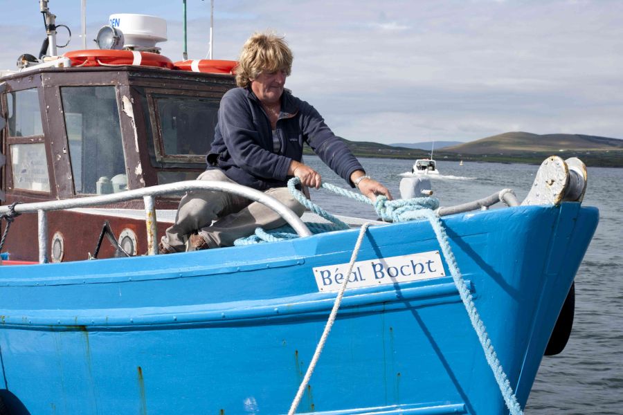 Knightstown, Valentia Island, County Kerry, Ireland. Fisherman with boat.