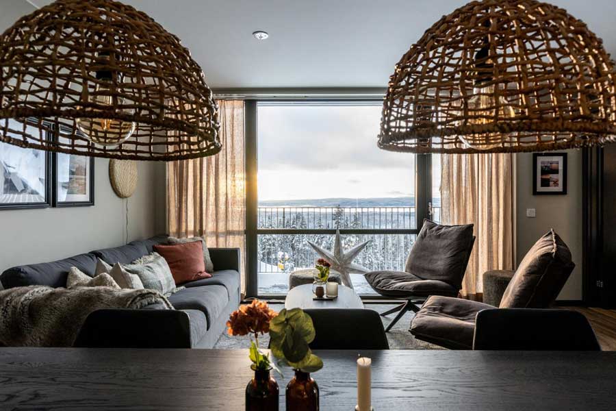 Woonkamer met uitzicht op de Zweedse en Noorse bergen vanuit een appartement van Parkbyn