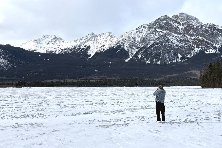 Man kijkt uit over de omgeving van Jasper vanaf het bevroren Pyramid Lake