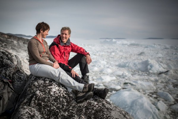 A couple on the shores of the Ilulissat ice fjord in Greenland